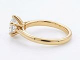 a close up of a diamond ring on a white surface