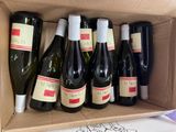 many bottles of wine in a box on the table
