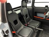 two seats in the back of a vehicle with a steering wheel