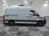 a white van with a ladder on top of it