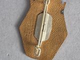 a small piece of leather with a metal clasp on it