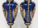 pair of blue and gold vases sitting on top of a table