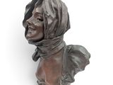 bronze bust of a woman wearing a scarf and a scarf around her head