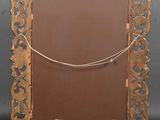 an old mirror with a chain hanging from it ' s side