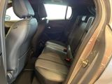 the back seats of a car with the door open and the driver ' s seat down