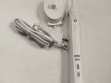 an image of a toothbrush and a charger on a table