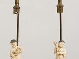 pair of antique chinese figurines of a boy and a girl on a pedestal
