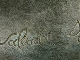 a close up of a statue of a dog with a name written on it