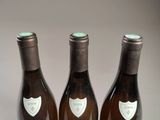 three bottles of wine sitting on top of a table next to each other