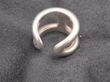 a close up of a silver ring on a black cloth
