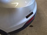 a close up of a car ' s rear bumper with a sticker on it