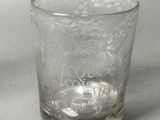 a glass with a design on it on a table