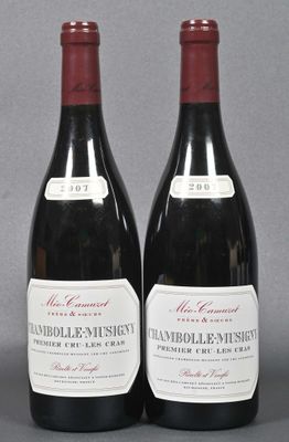 two bottles of red wine sitting next to each other on a table