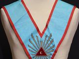 an image of a blue and red vest with a triangle on it