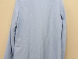 the back of a light blue jacket hanging on a hanger
