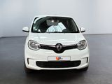 the white car is parked in a large room with a black floor
