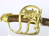 a close up of a sword with a gold decoration on it