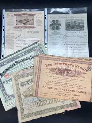 several old french currency notes are on a black surface