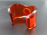 a close up of a red plastic bracelet on a table
