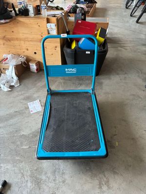 a blue hand truck that is sitting in a garage