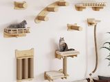 a cat sitting on a cat tree in a living room