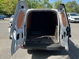 a white van with its doors open in a parking lot