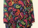 a black dress with multicolored paisley print on it