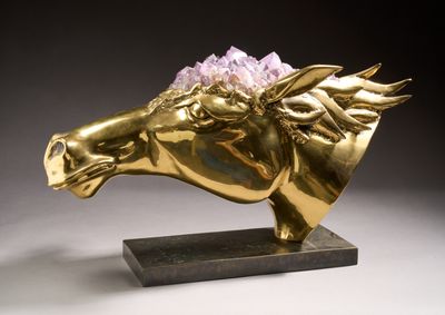 sculpture of a golden horse with a flower on its head