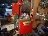 a red machine that is sitting in a garage