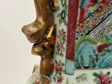 a large vase with a lion head on it ' s side