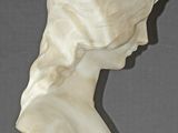 marble bust of a woman with a flower in her hair