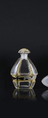 two perfume bottles sitting next to each other on a table