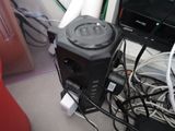 a black power outlet on the floor next to a laptop