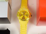 a yellow watch sitting on top of a table next to a box