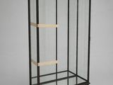 a black and gold display case with a bird on top of it