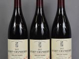 three bottles of wine sitting on a table next to each other