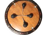 a wooden clock with four black knobs on it