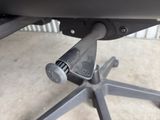 a close up of a desk chair with a metal base