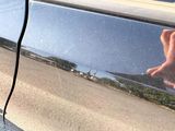 a close up of a person ' s hand on the door of a car