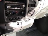dashboard of a car with a hand on the steering wheel and a hand on the steering wheel