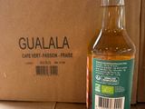 a bottle of liquid sitting next to a box on the floor