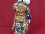 a figurine of a woman wearing a kimono