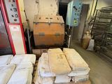 several stacks of mattresses are stacked on pallets in a warehouse