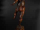 a bronze statue of an angel on a pedestal