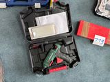 a box of tools on the floor next to a pair of shoes