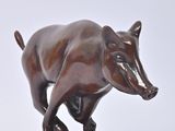statue of a bull on a wooden base on a white background