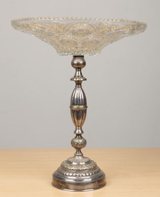 a close up of a silver plate on a wooden table