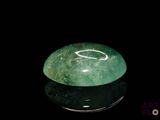 an image of a green jade stone on a black surface