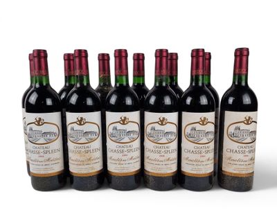 six bottles of wine are lined up in a row on a white surface