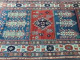 an oriental rug on a wooden floor with a blue and red design